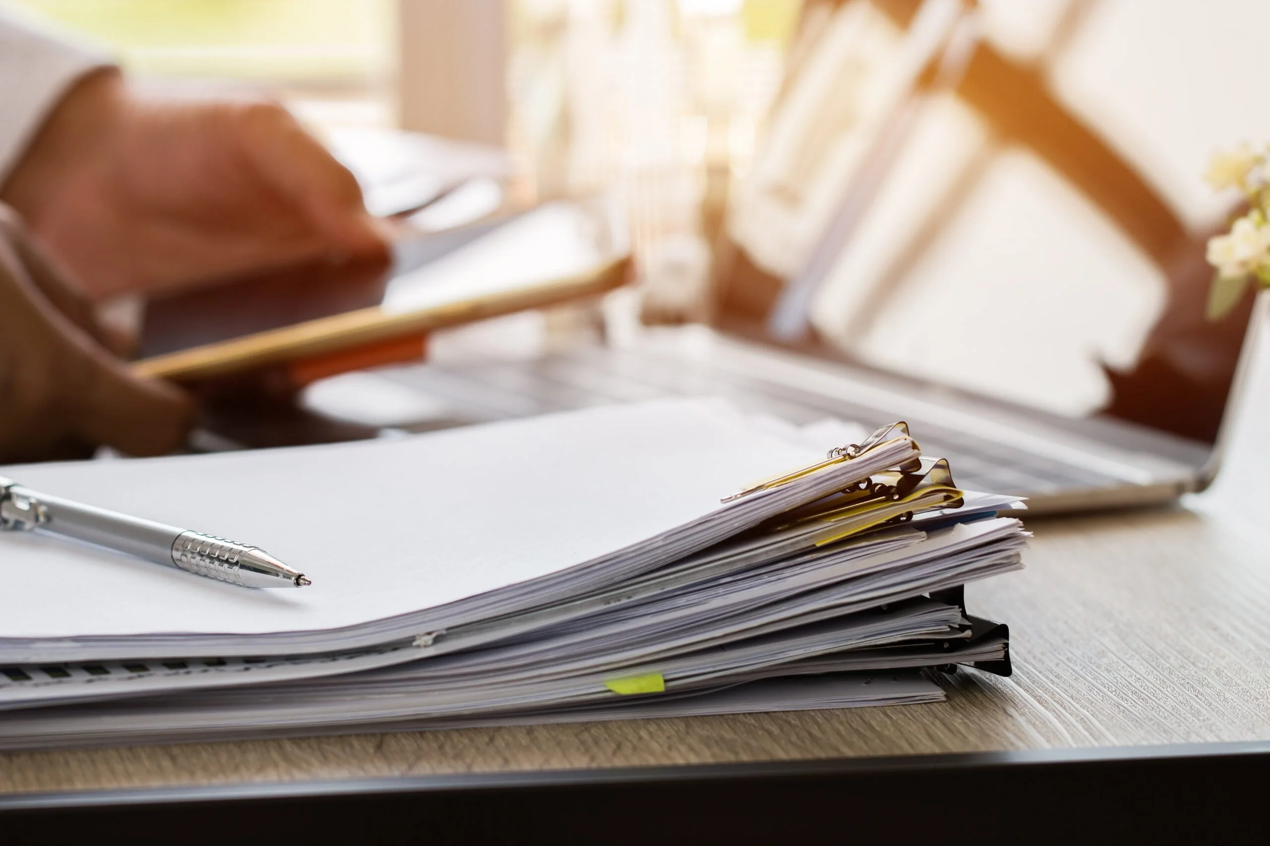 paper stack pile unfinished documents office desk business functions scaled