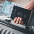 พาสปอร์ต หนังสือเดินทาง people holding passports coronavirus vaccination card map travel with luggage trip covid 19 around world scaled พาสปอร์ต วีซ่า