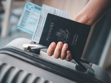 พาสปอร์ต หนังสือเดินทาง people holding passports coronavirus vaccination card map travel with luggage trip covid 19 around world scaled พาสปอร์ต วีซ่า